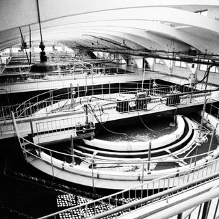 Large, tiered circular tanks with railings and machinery.