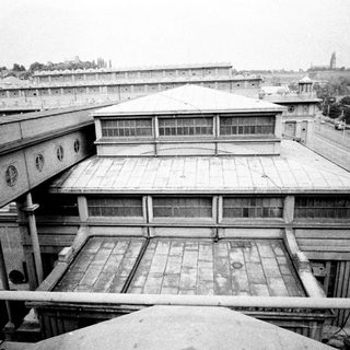 Overhead view of a large, institutional building with surrounding cityscape.