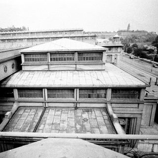 Overhead view of a large, institutional building with surrounding cityscape.
