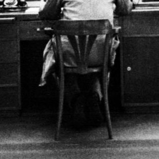 Man working at control panel in a monitoring room.