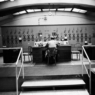 Operator monitors equipment in a control room.