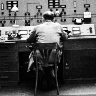Operator monitors equipment in a control room.
