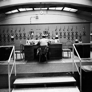 Operator monitors equipment in a control room.