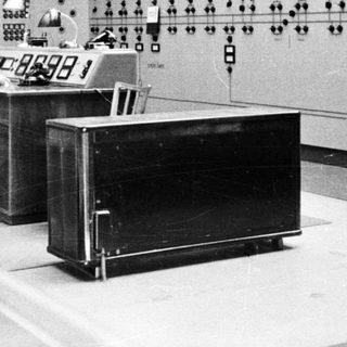 Control room with operators monitoring complex electrical systems.