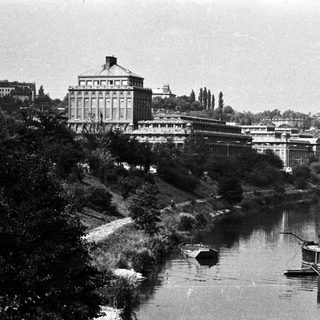 Industrial building and river with a steamboat.