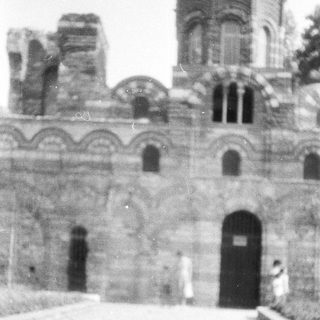 Black and white photograph of an old stone building facade.