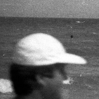 Black and white photo of people at a beach.