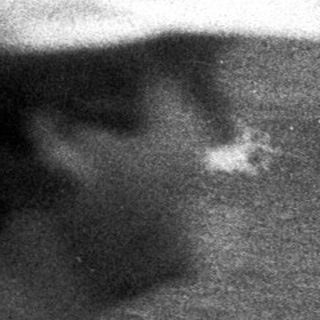 Black and white photo of people at a beach.