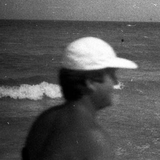 Black and white photo of people at a beach.