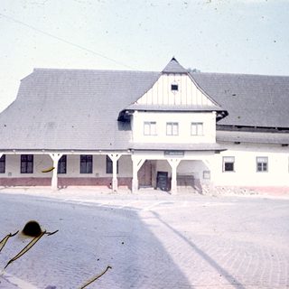 A vintage photograph of a historic train station building.
