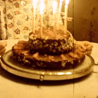 Young girl with a birthday cake and candles.