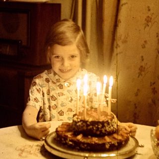 Young girl with a birthday cake and candles.
