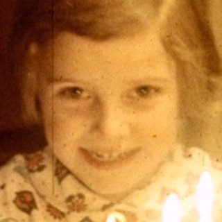 Young girl with a birthday cake and candles.