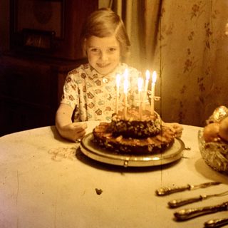Young girl with a birthday cake and candles.