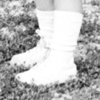 Black and white image of a young girl in a coat.