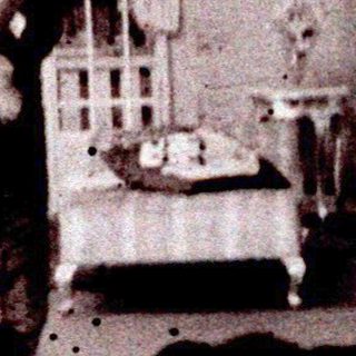 Man on stage, appearing in a staged indoor scene.