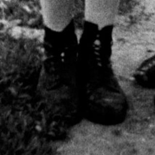 Black and white photo of a girl and woman standing outside.