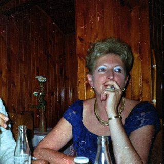 Couple seated at a table in a wood-paneled room.