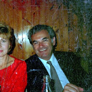 Three people seated at a table, smiling for a photo.