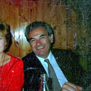Three people seated at a table, smiling for a photo.