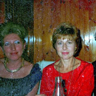 Three people seated at a table, smiling for a photo.