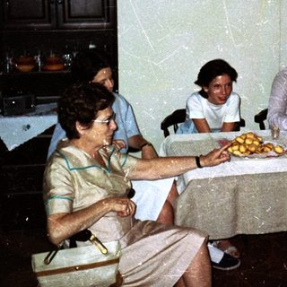 Four people seated around a table in a dining room.