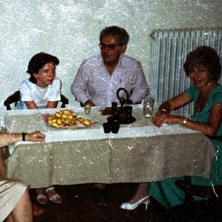 Family seated around a table in a vintage dining room.
