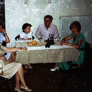 Family seated around a table in a vintage dining room.