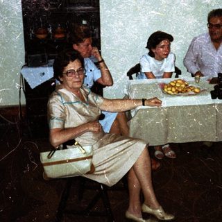 Family seated around a table in a vintage dining room.