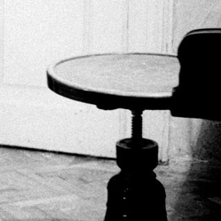 Here's a brief summary of the image: A young girl stands with two women in a home.