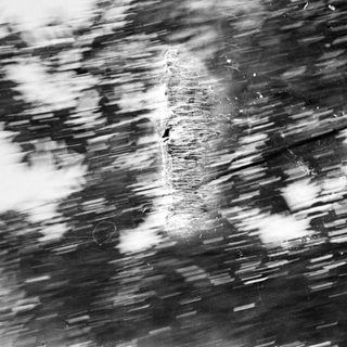 Blurred image of a damaged, scratched, or worn surface.