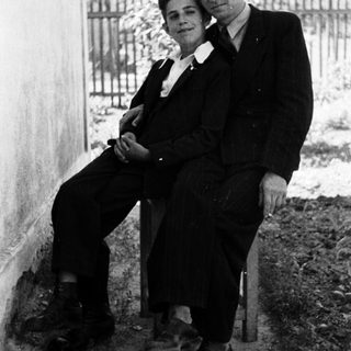 Black and white photo of a couple seated outdoors.