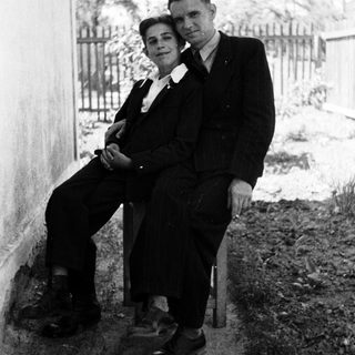 Black and white photo of a couple seated outdoors.