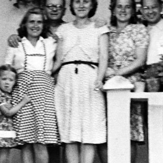 Family portrait on a porch, circa mid-20th century.