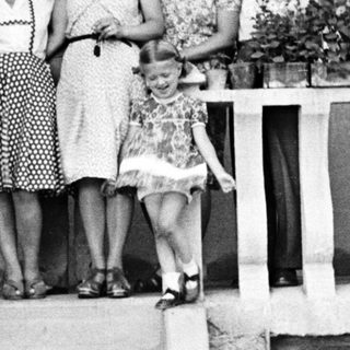 Family portrait on a porch with flower planters.