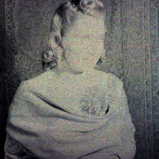 Here's a brief summary of the image: Faded portrait of a person with ornate wallpaper background.
