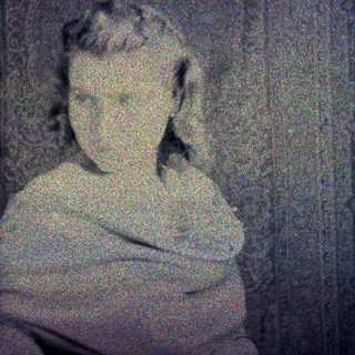 Here's a brief summary of the image: Marble bust of a woman against a patterned background.