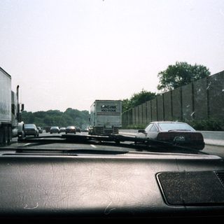 Traffic on a highway, viewed from inside a car.