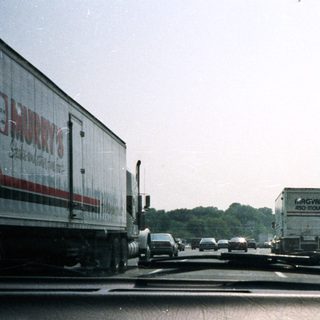 Traffic on a highway, viewed from inside a car.