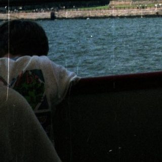 The Statue of Liberty is visible from a boat.