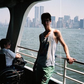 Person on a ferry with a New York City skyline view.