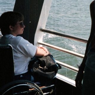 Person on a ferry with a New York City skyline view.