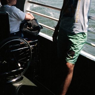 Person on a ferry with a New York City skyline view.
