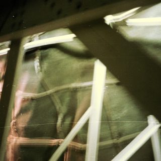Blurred photo showing a person and fluorescent lights.