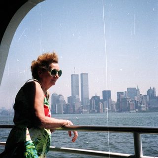 Woman on boat overlooking New York City skyline.