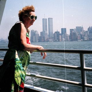 Woman on boat overlooking New York City skyline.