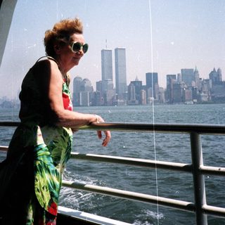 Woman on boat overlooking New York City skyline.