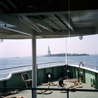 Ferry deck view with the Statue of Liberty in distance.