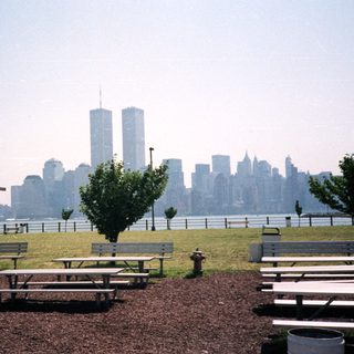 Park picnic tables with World Trade Center in background.