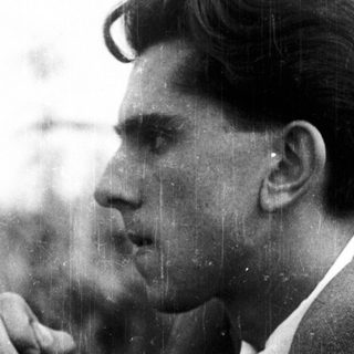 Man in suit looks pensive in side profile.